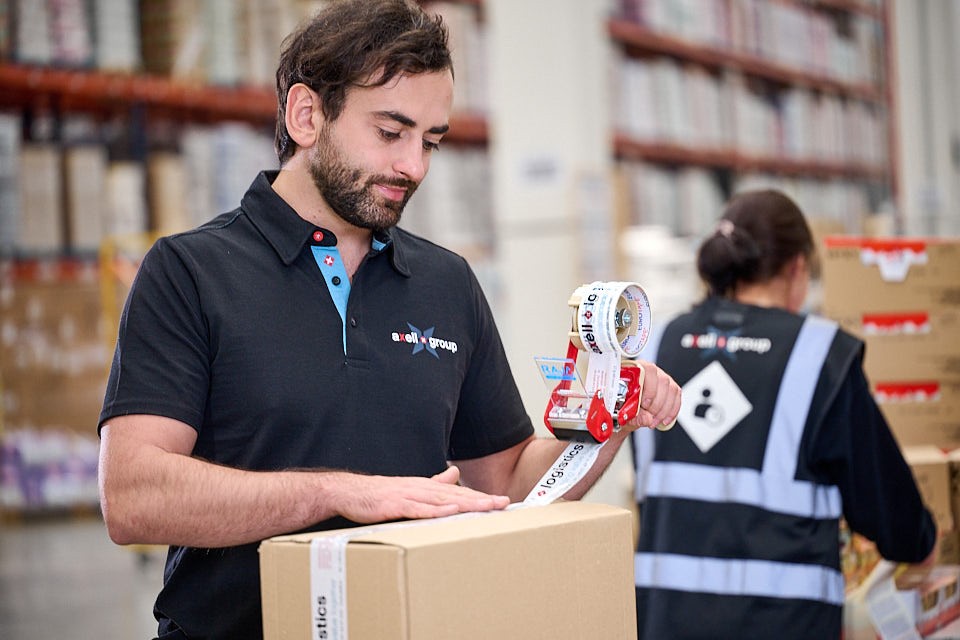 Man packaging boxes in warehouse