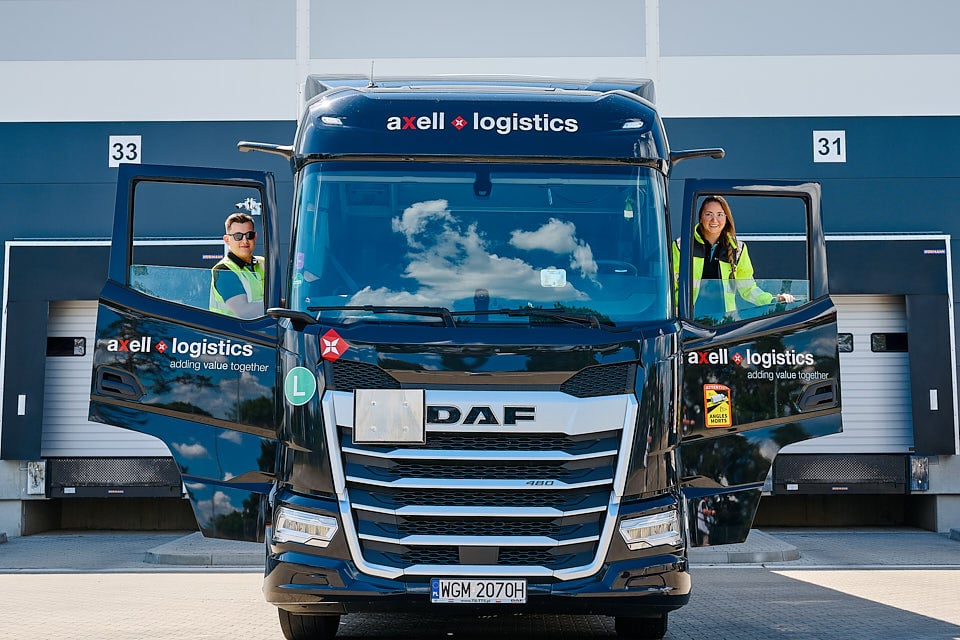 Truck drivers in front of a logistic warehouse